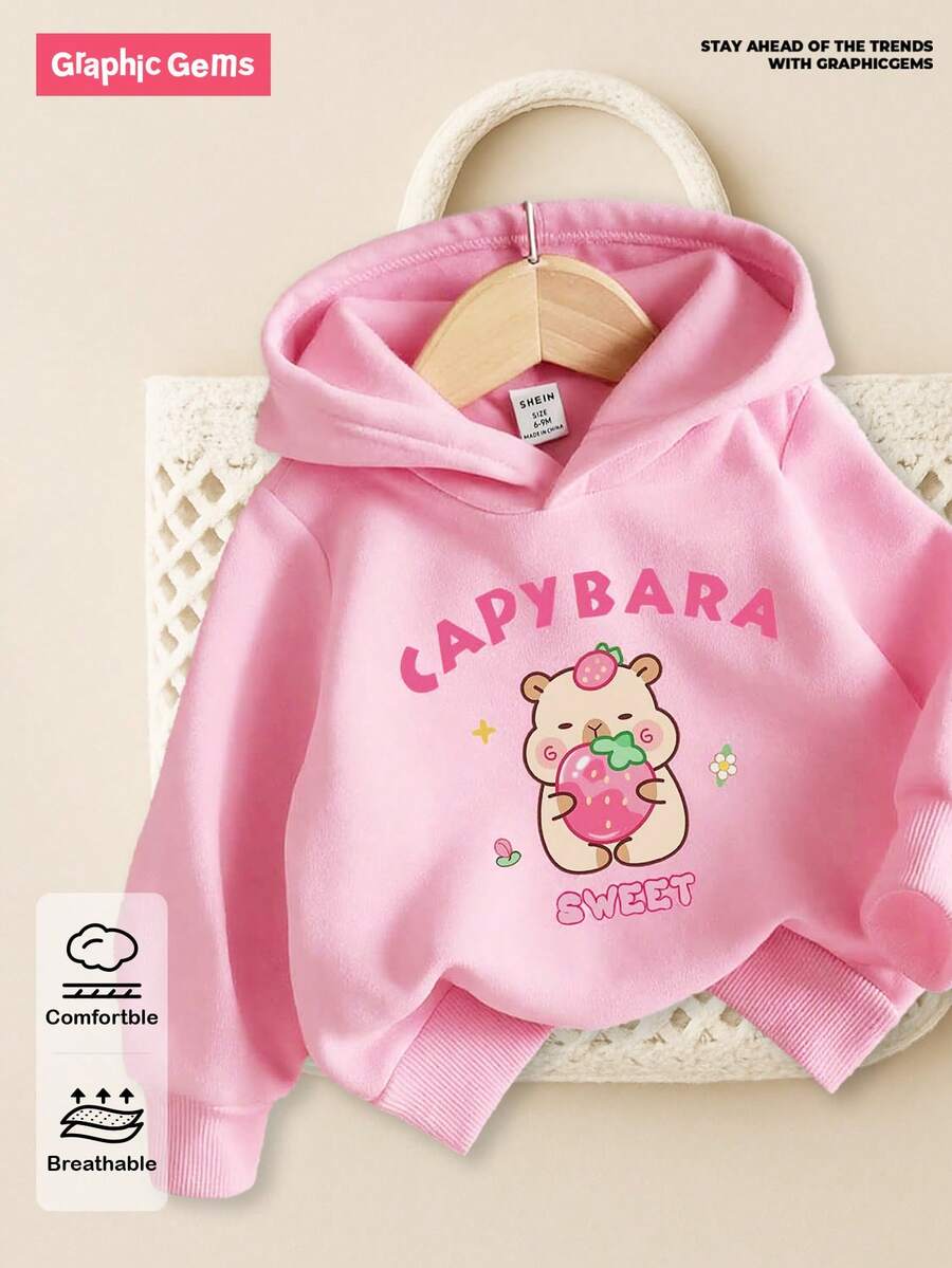 SHEIN 6个月-3岁可爱水豚印花连帽套头衫,适合女婴,男女通用,适合春季、秋季、冬季,休闲、运动、通勤皆宜。女婴卫衣,水豚服装,草莓服装,粉色水豚卫衣,女婴粉色卫衣,女婴服装,女婴服装 - 彩色 - 查看 1