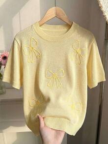 Elenzga Blusa de punto holgada y versátil de manga corta con cuello redondo y decoración bordada en 3D con lazo en color amarillo mantequilla para mujer - Amarillo - Ver 1