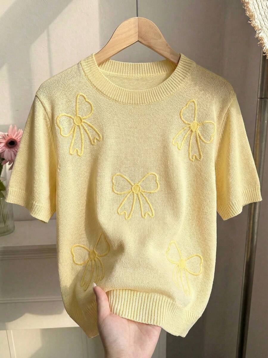 Elenzga Blusa de punto holgada y versátil de manga corta con cuello redondo y decoración bordada en 3D con lazo en color amarillo mantequilla para mujer - Amarillo - Ver 1