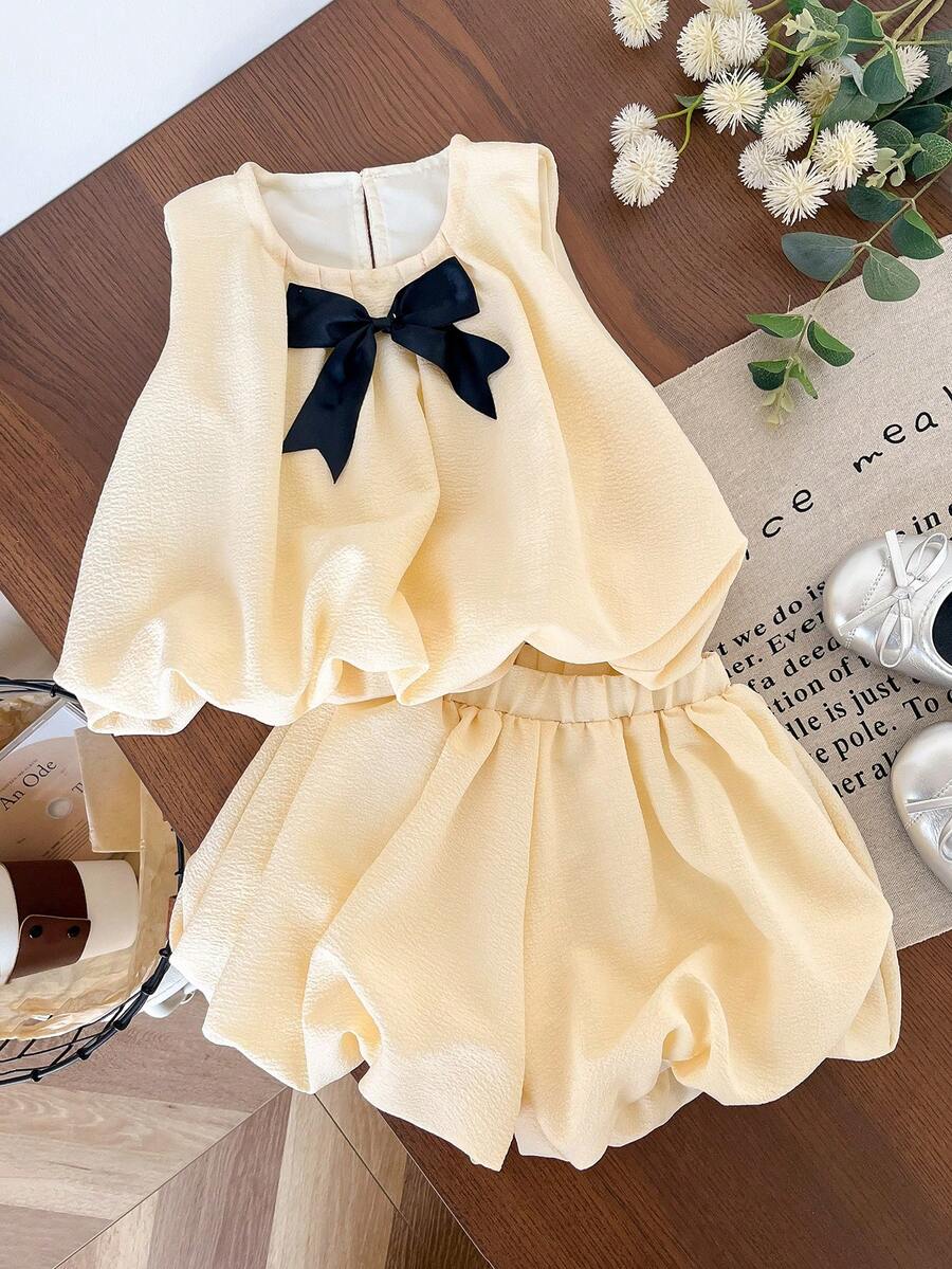 Genkimix Kids Bộ 2 món cho bé gái: Áo không tay trang trí nơ và quần short màu trơn. - Màu vàng - Xem 1