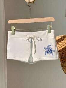 Comfortcana Quần short nữ dáng ôm màu trắng, tối giản, in hình rùa biển xanh trắng, cạp chun, dây rút – Thích hợp mặc đi biển mùa hè và nghỉ dưỡng bên bờ biển, thoải mái cho mùa xuân/hè, dễ thương, mềm mại, phong cách boho, đảo nhiệt đới, lễ hội, hẹn hò, lễ hội âm nhạc và kỳ nghỉ xuân. - trắng - Xem 4