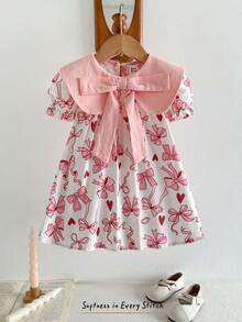 Cozy Pixies Đầm bé gái in hoa, cổ tròn, tay phồng, thắt eo, nơ to. - Nhiều màu - Xem 5