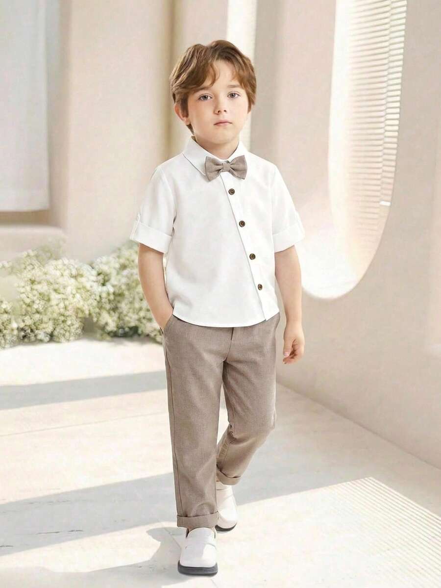 SHEIN 2pcs Young Boy Gentleman Outfit, Cute Khaki Elastic Waist Pants And Short Sleeve Shirt With Bow Tie, Spring/Summer - Khaki - View 1