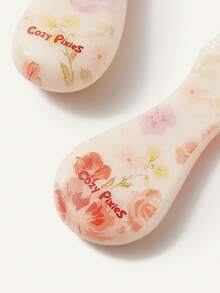 Cozy Pixies 两件套婴儿护理工具，包括梳子和花朵造型发刷，可轻柔梳理头发，也可用于婴儿洗澡。 - 彩色 - 查看 10