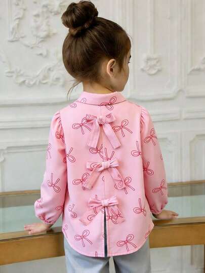 Camisa para niñas con base de color rosa claro + elemento de lazo, combinando mangas farol y decoraciones 3D, con un estilo general dulce y lindo, adecuado para la escuela diaria, salidas y reuniones casuales en primavera y otoño