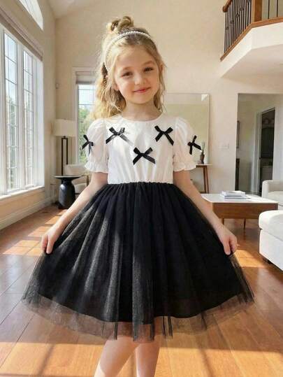 Elladie kids Toddler Girls' Black & White Patchwork Mesh Dress, Round Neck Short Sleeve With Bow Decor, A-Line Mesh Skirt, Suitable For Various Body Types. Puff Sleeve Design, Sweet And Playful. Suitable For Outdoor Play Or Casual Wear, Showcasing Baby's Lively And Elegant Charm.