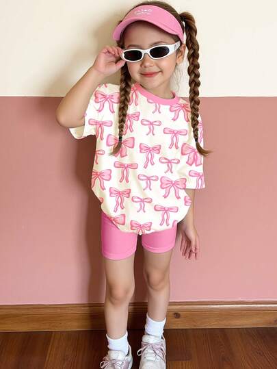 SHEIN Bright Pink, Sweet & Fashionable Bow Graphic Print, Young Girl Casual Minimalist Comfortable Round Neck Loose Short Sleeve T-Shirt And Tight Fitting Knee Length Leggings Set, Suitable For Spring/Summer Daily Wear, Street Style, Outings, Home, Vacation