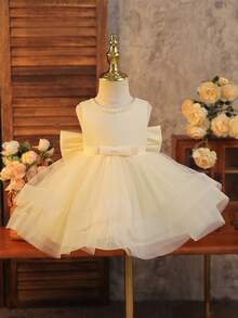 SHEIN Glamorique Kids 女婴杏色网纱蓬蓬裙，无袖方领，带大蝴蝶结装饰，适合派对穿着。休闲修身短款公主裙，杏色无袖蓬蓬裙，带蝴蝶结，适合花童跳舞，蝴蝶结，女婴杏色裙摆，双层网纱连衣裙，白色珍珠使人自信骄傲，连衣裙，钢琴演奏，蓬蓬裙，舞会礼服，夏季，春季婴儿蓬蓬裙，香槟色婴儿连衣裙，象牙色婴儿连衣裙，女婴连衣裙，优雅婚礼女婴蝴蝶结连衣裙 - 杏色 - 查看 3