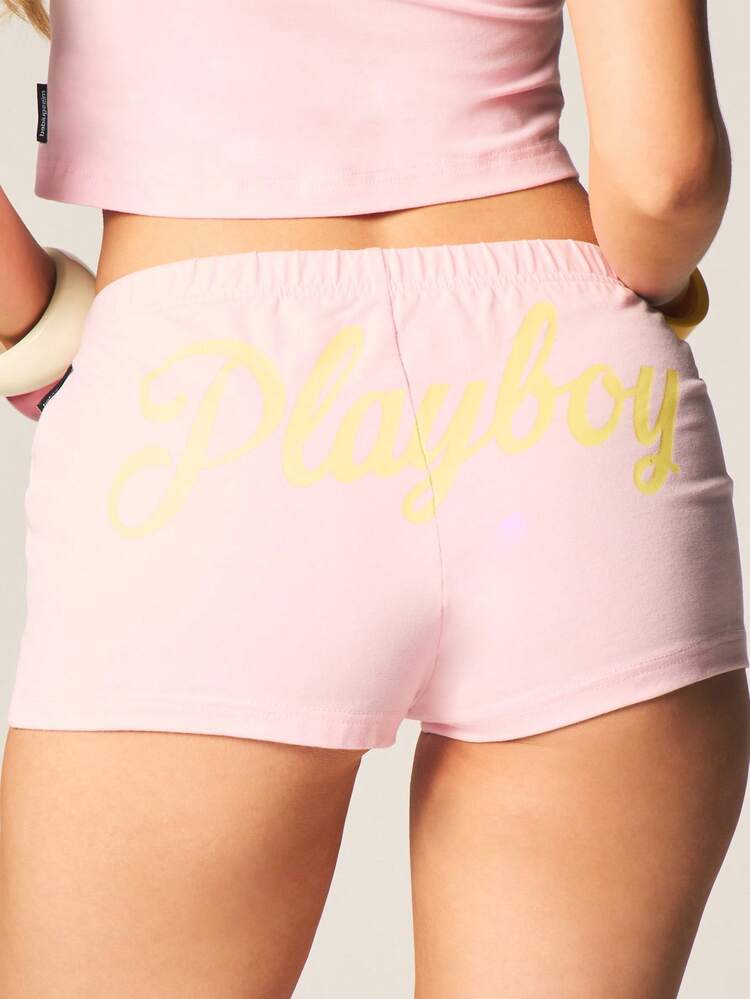 Missguided x Playboy Short de sport taille haute en coton mélangé, longueur mini, style graphique, rose vif, stretch, cordon de serrage. Idéal pour les festivals d'été et la détente.