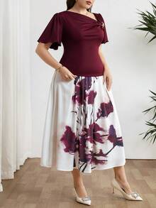 Modelyn Bộ đồ 2 món thanh lịch dành cho nữ cỡ lớn, màu trơn, trang trí kim loại, cổ áo bất đối xứng, tay ngắn và chân váy midi in hoa. - Nhiều màu - Xem 8