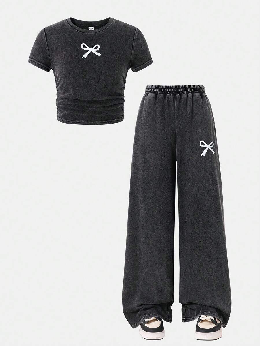 SHEIN Conjunto informal de 2 piezas para niña preadolescente con camiseta de cuello redondo plisada con lazo decorativo y pantalones de corte holgado de unicolor - Rosa - Ver 1