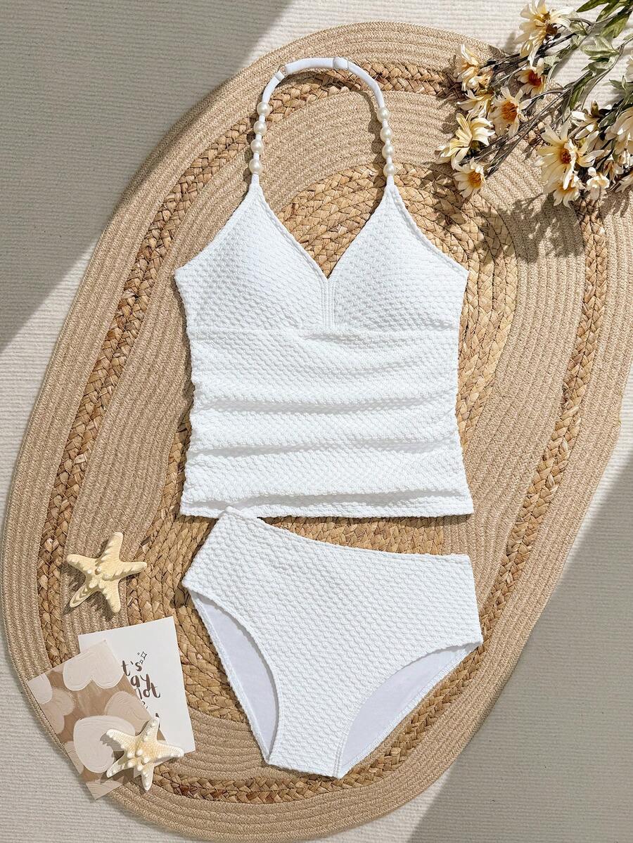 SHEIN 少女两件套荷叶边吊带泳衣套装,白色特殊面料,三角泳裤,时尚休闲优雅泳装,适合游泳、度假、夏季穿着。白色吊带泳衣,少女白色吊带泳衣,适合青少年穿着。白色少女两件套泳衣,款式保守。白色少女两件套比基尼,款式保守。米色少女比基尼套装,全包覆式保守抹胸上衣,适合海滩穿着。白色少女沙滩上衣,少女两件套保守泳衣。两件套泳衣,女童泳衣。 - 白色 - 查看 1