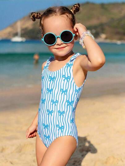 SHEIN Traje de baño de una pieza con estampado de lazos y olas azules para niña, elegante y casual, adecuado para nadar, vacaciones y verano (el diseño del estampado puede variar)