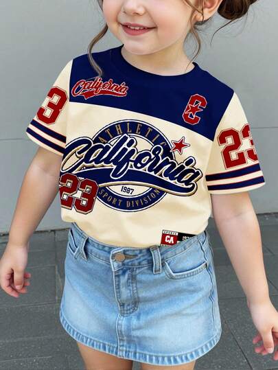 SHEIN Retro American College Style Sports Numeric 23 Print, Young Girl Casual Minimalist Round Neck Short Sleeve T-Shirt Suitable For Summer, Cute Summer Outfits For Outing, Summer Kids Items, Summer Outing Items, Korean Style, Easy Comfort, Stylish Kids, Y2K, Kawaii, Party, Everyday, Vacation, Cute, Comfy, Outing, Summer 2026, Cottagecore, Weekend Casual, Family Outing, Photoshoot Outfits, Chill Chill, Baby & Kids Graphic Tops