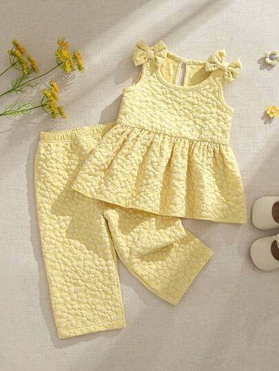 Souflis Souflis Baby Girl Cute Casual Minimalist Spring/Summer Yellow Solid Textured Woven Fabric Camisole And Wide Leg Pants Set, Designed With A Minimalist And Fashionable Style, Incorporating Adorable Elements Such As 3D Bow Shoulder Decoration And Ruffle Hem, Very Suitable For Baby's Daily Wear, Outings, Or Relaxed Family Gatherings