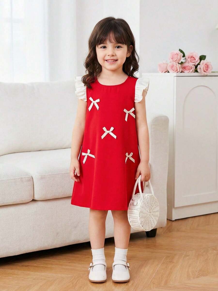 Sukienka bez rękawów dla młodej dziewczyny w kolorze czerwonym z białymi falbankami na ramionach i kokardką, słodki i żywy styl, odpowiedni dla każdego typu sylwetki, przyciągająca wzrok i urocza czerwona sukienka dla młodej dziewczyny w kolorze czerwonym - Czerwony - Zobacz 1