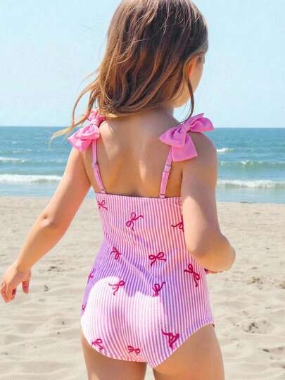 SHEIN Traje de baño de una pieza con estampado de rayas y decoración de lazo en el hombro para niñas en vacaciones de verano en la playa