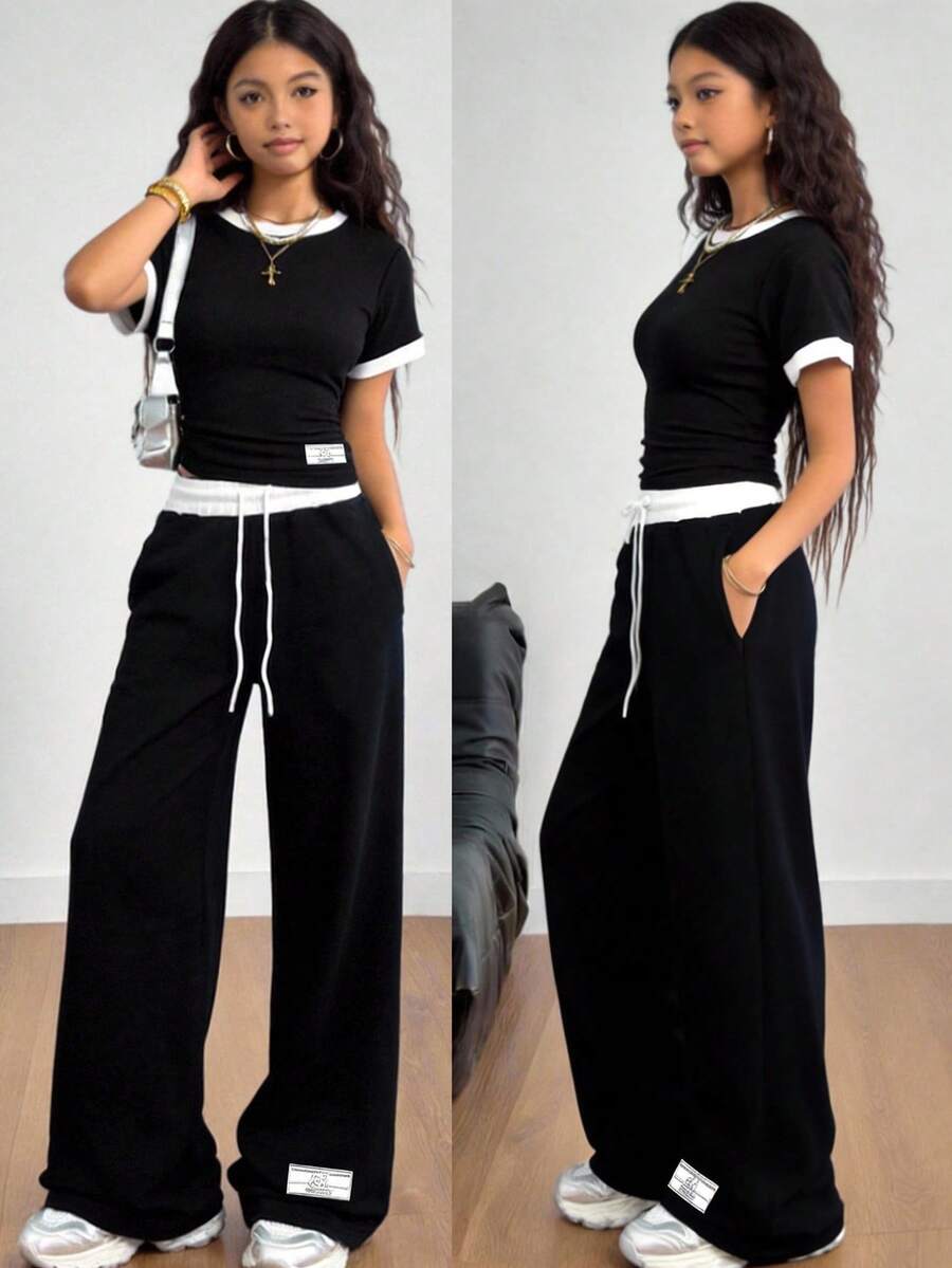 SHEIN Bộ đồ thể thao nữ tuổi teen gồm áo thun dệt kim gân phối màu tương phản ôm sát và quần ống rộng có túi cạp tương phản, thích hợp cho mùa xuân/hè, mặc thường ngày, chơi thể thao, đi học, bóng đá, hoạt động ngoài trời. - Đen và trắng - Xem 1