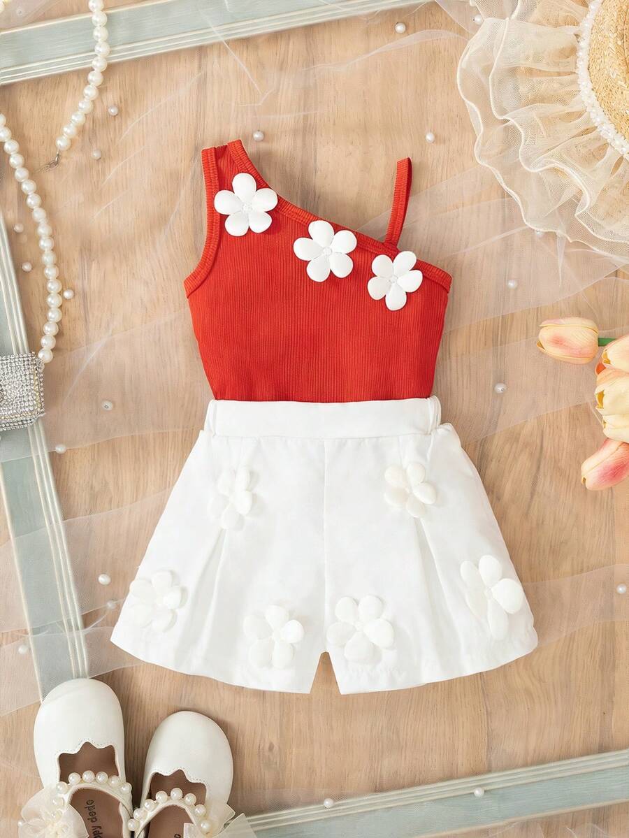 SHEIN Outfit alla moda coreana per bambine, decorazione floreale, set da 2 pezzi con canottiera a bretelle e pantaloncini eleganti, estivo - Arancione - Visualizzare 1