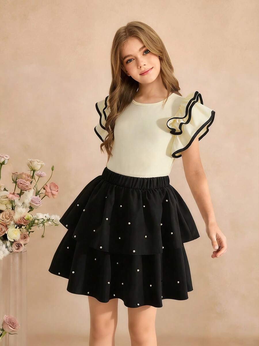 SHEIN 女童时尚两件套：杏色针织无袖上衣，饰有3D荷叶边和撞色抽绳，搭配黑色多层串珠裙摆半身裙，适合日常穿着及各种场合。 - 杏色 - 查看 1