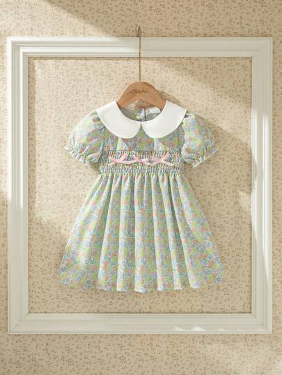 Souflis Souflis Đầm hè kiểu Pháp mới cho bé gái, họa tiết hoa nhí dễ thương cổ điển, cổ áo trắng phối màu tương phản, thiết kế xếp ly phía trước, trang trí nơ 3D tinh tế, phù hợp cho mặc thường ngày, đi nghỉ mát và dã ngoại.