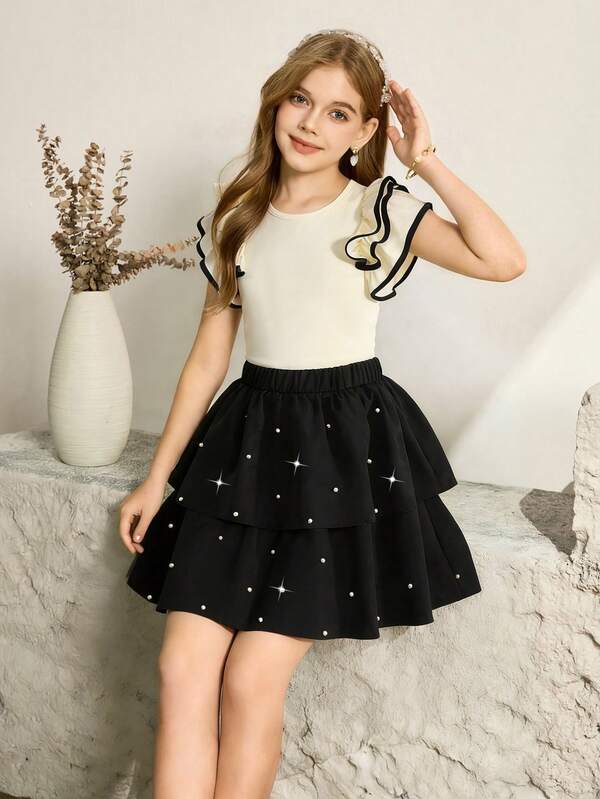 SHEIN Girls' Fashionable 2 Pieces Set: Apricot Knit Sleeveless Top With 3D Ruffle Trim And Contrast Drawstring, Paired With Black Layered Beaded Hem Skirt, Suitable For Daily Wear And Various Occasions