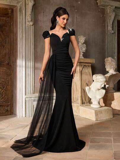 Aureia Elegant, Glamorous, And Stylish Black Sequined Embroidered Stretch Knit Dress With Sequined Ribbon Embellishments. Features A V-Neck, Puff Sleeves, And A Fishtail Hem With Flowing Sleeves. Suitable For All Formal Occasions, Wedding Guests, And Elaborate Evening Gowns.