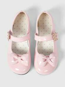 Pink shiny leather + polka dot bow.
