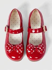 Red shiny leather + polka dot bow.