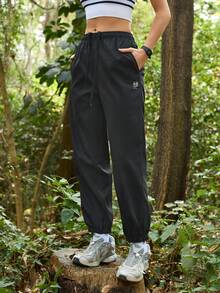 Exploreva Women's Drawstring Waist Pockets Casual Outdoor Running Pants - Black - View 1