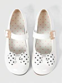 White shiny leather + polka dot bow.