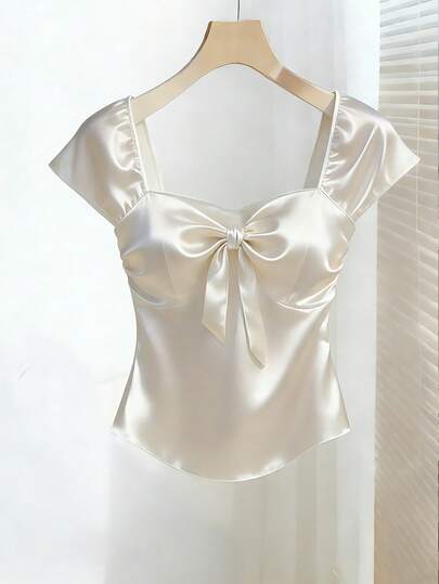 Franclia Women's Top, Women's Sleeveless Backless Top, Short, White, Solid Color, Pure Desire Top, Perfect For Valentine's Day Dates And Romantic Outfits. Features A Bow Design On The Chest, Exuding A Romantic Atmosphere. Made Of Tulle Satin Material, It Showcases Elegance And Noble Charm. A New Fashion And Stylish Evening Top, Perfect For Formal Events, Guest Attire, And Party Birthday Outfits. Satin Top Bow Top Satin Blouses For Women Women Tops Elegant Silk Top