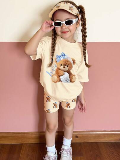 SHEIN Young Girl Casual Cream Yellow Cute Bear Print Soft Comfortable Loose Round Neck Short Sleeve T-Shirt And Bike Shorts Set, Suitable For Spring/Summer Daily Wear & Street Style