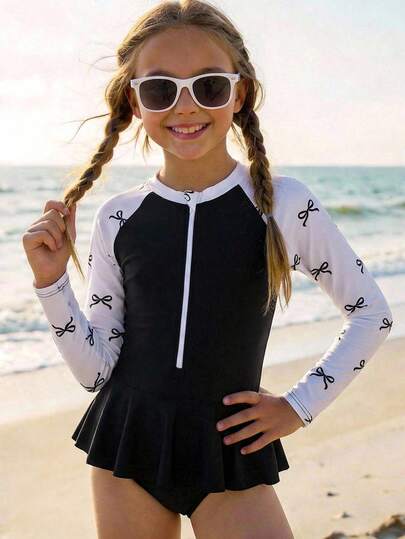 SHEIN Tween Girls' Black & White Half-Zip Raglan Sleeve Contrast Bow Print Long Sleeve Ruffled One-Piece Swimsuit With Flared Skirt, Bowknot Swimsuit, Girls' Conservative Beach Dress, Black Beach Dress, Girls' Swimwear, Swimsuit With Rash Guard, Kids' Rash Guard, Two Pieces Long Sleeve Swimsuit, Girls' Conservative Swimsuit, Girls' Rash Guard Set, Black & White Shirt And Pants Set, Suitable For Swimming And Beach Wear, Popular Swimwear, Must-Have For Summer Vacation, Beach, Summer Outing