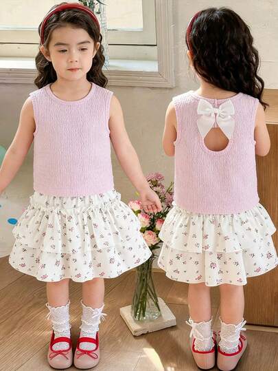 2pcs/Set Young Girls' Vest Top & Floral Skirt Set, Spring/Summer. Pink Sleeveless Top With Hollow Circle Back Design And White Bow Accent, Paired With Apricot Layered Ruffle Ditsy Floral Skirt With Elastic Waist, Fitted Silhouette, Soft & Comfortable Fabric, Fashionable Everyday Outfit