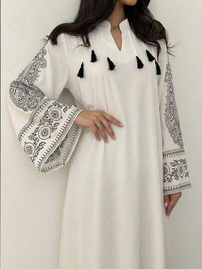 Al Najma Women's Spring/Summer Woven Placement Print Mandarin Collar Tassel Pendant Long Sleeve Elegant Arabic Dress White Black Embroidered Tassel V-Neck Long Sleeve Maxi Elegant Boho Embroidered Tassel Modest Maxi Chic V-Neck Embroidered Tassel Sleeve Maxi Spring Break Vacation Boho Embroidered Maxi Dress V-Neck + Long Sleeve + Black Embroidered Cuff + Tassel Detail + Maxi Length