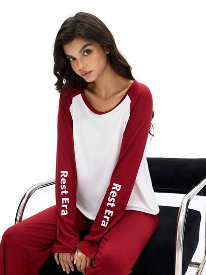 SHEIN 女士睡衣套装，上衣采用插肩袖设计，主体为白色，肩部和袖子为酒红色，袖子上印有白色“Rest Era”字样；下装为纯酒红色长裤。整体设计融合了对比鲜明的色彩和文字元素，风格简约，又不失品牌感。