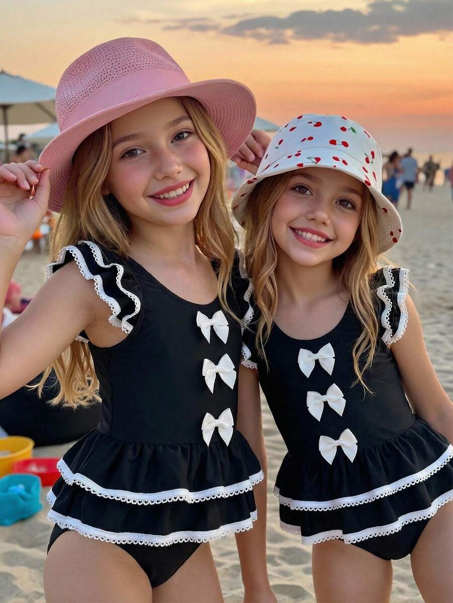 SHEIN Emery Rose Kids Young Girl Contrast Binding Ruffle Armhole Bow Front One-Piece Swimsuit, Summer Beach Vacation Style Girls Black And White Beach Outfit Young Girl Swimsuit Black And White Twin Girl Beach Clothes Black Bathing Suits For Girls Girls Black With White Bows Cute Young Girl And Baby Girls Black Ruffled Swimsuit With White Trim And Bows Sweet Beach Outfit - Black - View 1