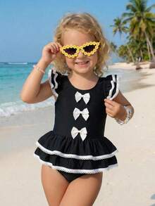 SHEIN Emery Rose Kids Young Girl Contrast Binding Ruffle Armhole Bow Front One-Piece Swimsuit, Summer Beach Vacation Style Girls Black And White Beach Outfit Young Girl Swimsuit Black And White Twin Girl Beach Clothes Black Bathing Suits For Girls Girls Black With White Bows Cute Young Girl And Baby Girls Black Ruffled Swimsuit With White Trim And Bows Sweet Beach Outfit - Black - View 4