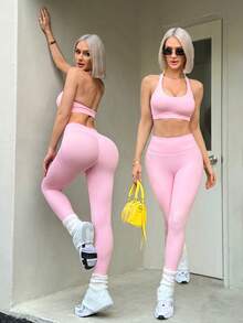 SHEIN Dewbera Bộ đồ tập yoga không đường may dành cho nữ gồm áo ngực và quần legging lửng 3/4, hở lưng, thời trang và gợi cảm, thoải mái khi mặc nhiều lớp, cạp cao giúp kiểm soát vòng bụng, tôn dáng, thích hợp cho tập thể dục, đa năng, chạy bộ ngoài trời. - Hồng - Xem 1