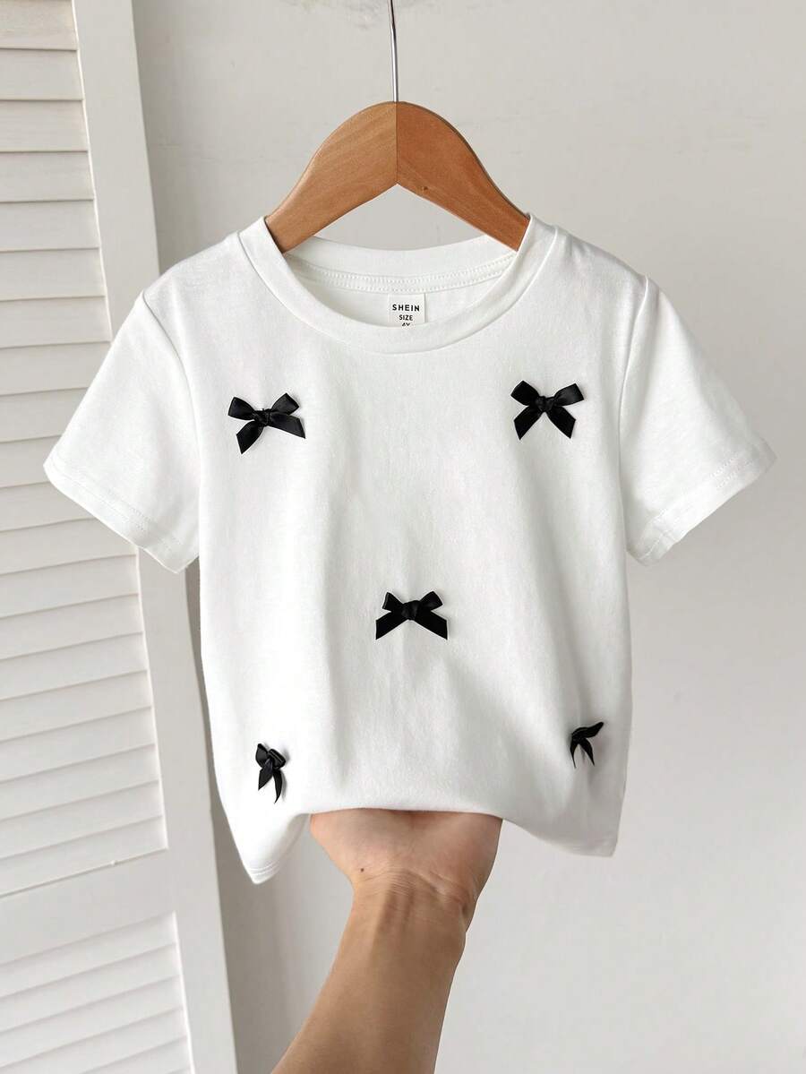 SHEIN Young Girls' Contrast Color Bow T-Shirt,Fashionable White Summer Kids Top,Versatile For Wedding,Sister Photo Shoots,Park,Camping,Vacation,Daily Wear - White - View 1