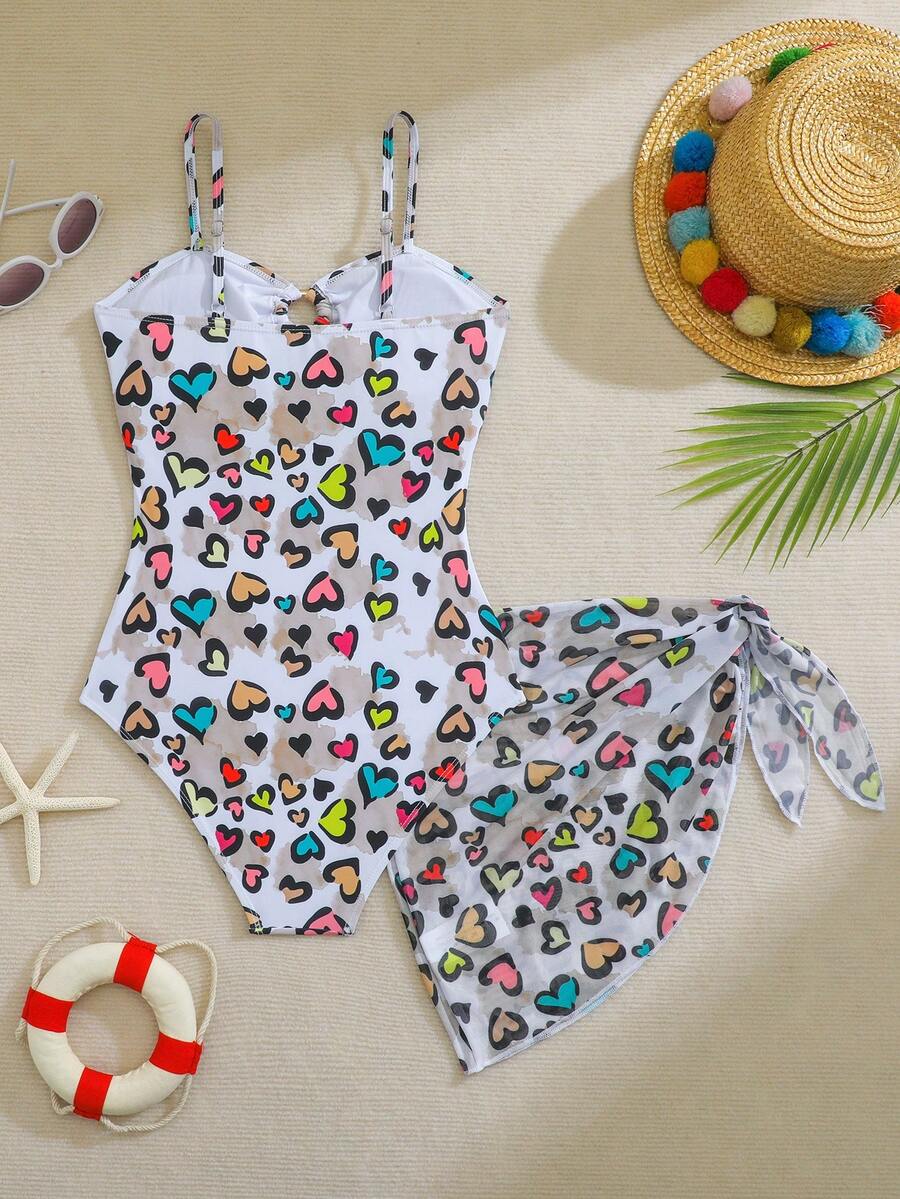 SHEIN Bộ áo tắm liền thân in hình trái tim dành cho thiếu nữ, kèm chân váy ngắn cùng màu, thích hợp cho kỳ nghỉ biển, tiệc bể bơi, tiệc bãi biển.