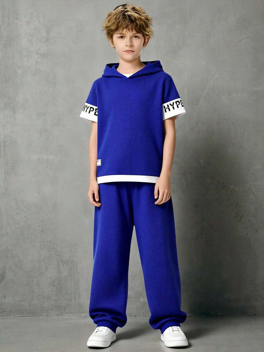 SHEIN Casuvi Kids 2pcs/Set Tween BoysSummer Outfit, Tween Boys Waffle Texture 2-Piece Set, Top Is A Casual Navy Blue Hooded Short Sleeve Sports T-Shirt With White Knit Fabric On Sleeves And Print, Bottom Is A Waffle Texture Sports Style Long Pants With White Graphic Print, Casual Sports Style Outfit Suitable For Daily Wear, Sports, Vacation, Holidays - Royal Blue - View 1