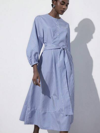 Aveloria Modichic Vertical Striped Woven Fabric, Navy Blue And White Color Scheme, Minimalist Versatile Style, Suitable For Spring And Autumn Daily Wear, Round Neck Open Front Design, Voluminous Sleeves, Waist Tie Detail, A-Line Midi Silhouette, Fine Combed Long Staple Fabric, Soft And Lightweight, Suitable For Commuting, Weekend Outings, Afternoon Tea Gatherings, Campus Life And Family Dinners, Showcasing A Clean And Elegant Feminine Charm. Fashionable Design Sense, Versatile Casual V-Neck Waist Cinched Puff Sleeve Long Striped Dress