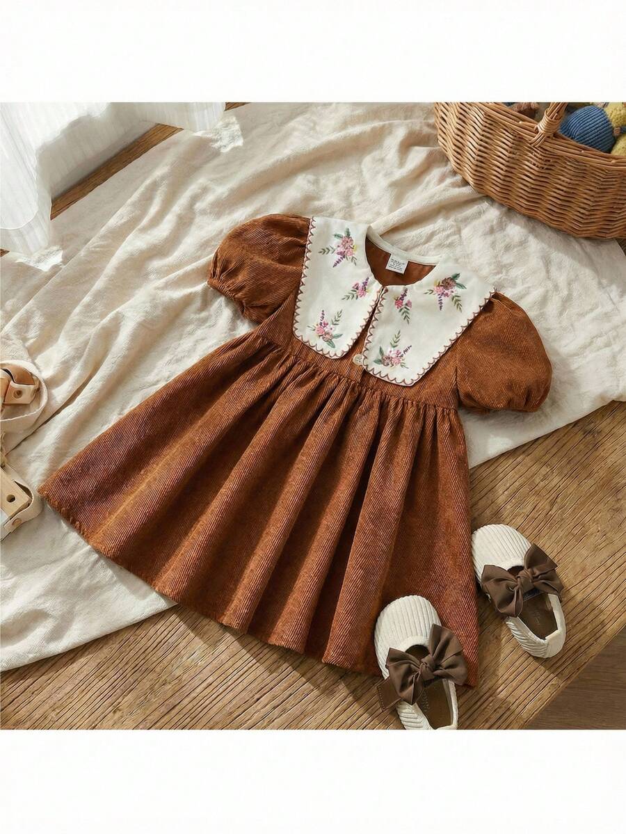 Loomiva Chân váy xếp ly chữ A kiểu dáng nghỉ dưỡng cho bé gái, chất liệu nhung kẻ mềm mại, cổ áo tương phản, cổ bẻ, cài khuy nửa thân, tay phồng ngắn kiểu đèn lồng. - màu nâu - Xem 1