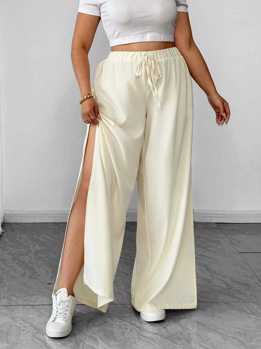 Elenzga Quần ống loe xẻ tà bên hông, chất liệu crepe có họa tiết, điểm nhấn nơ phía trước, kiểu dáng suông rộng rãi dành cho nữ. - Màu be - Xem 1