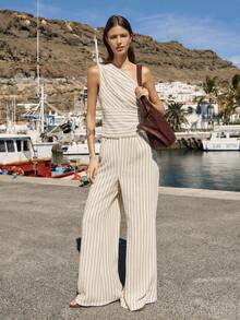 Nöista 这款米色条纹单肩上衣搭配高腰阔腿裤套装，优雅大方，宽腰带设计凸显腰部线条。面料抗皱、触感柔软，垂感和透气性俱佳，是春夏度假造型的理想之选。 - 杏色 - 查看 6