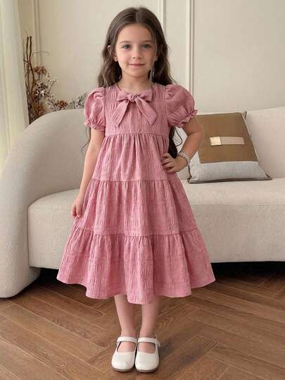 SHEIN Young Girl Woven Solid Color Round Neck Puff Sleeve Bow Decor Casual Dress Dusty Rose Dress Kids Girl Midi Dress Little Girls Dress Bow Ruffle Dress Kids Casual Dress Little Girls Linen Dress Solid Color Bow Dress Ruffle Strap Casual Dress