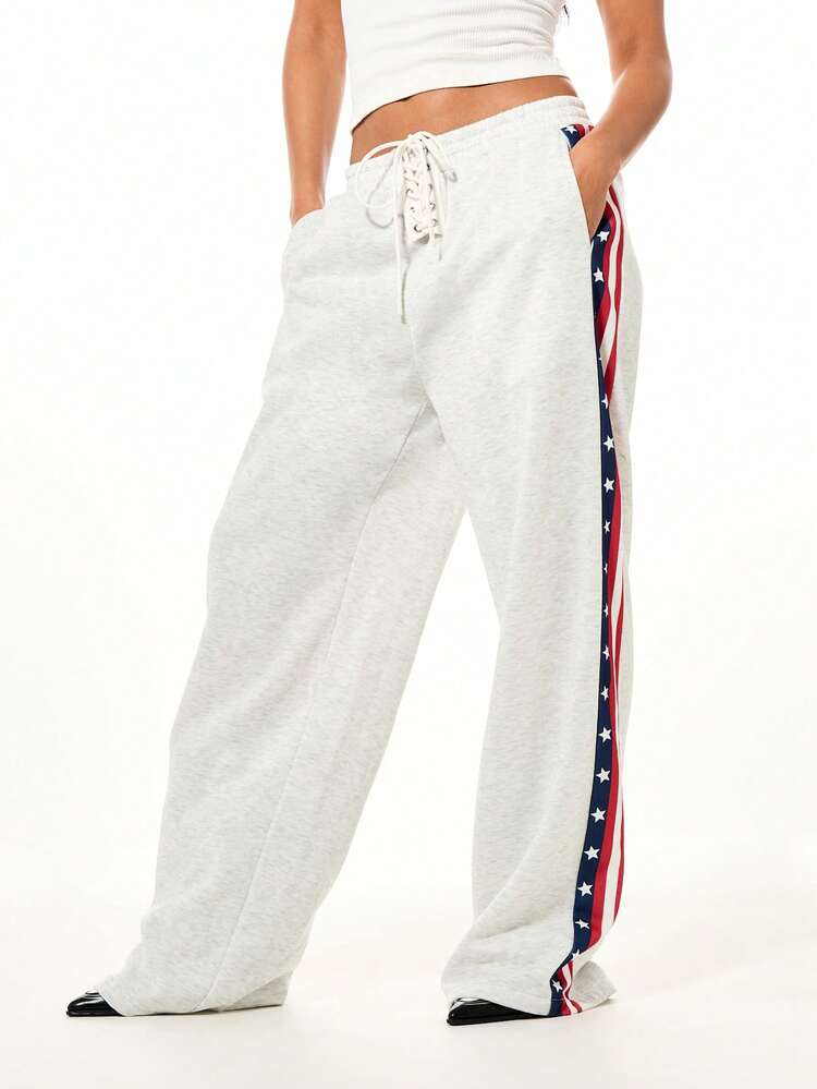 SUMWON WOMEN Patriotic Wide Leg Joggers With USA Flag Side Stripe Design And Lace Up Front Waist Tie Detail For Casual Weekend Wear