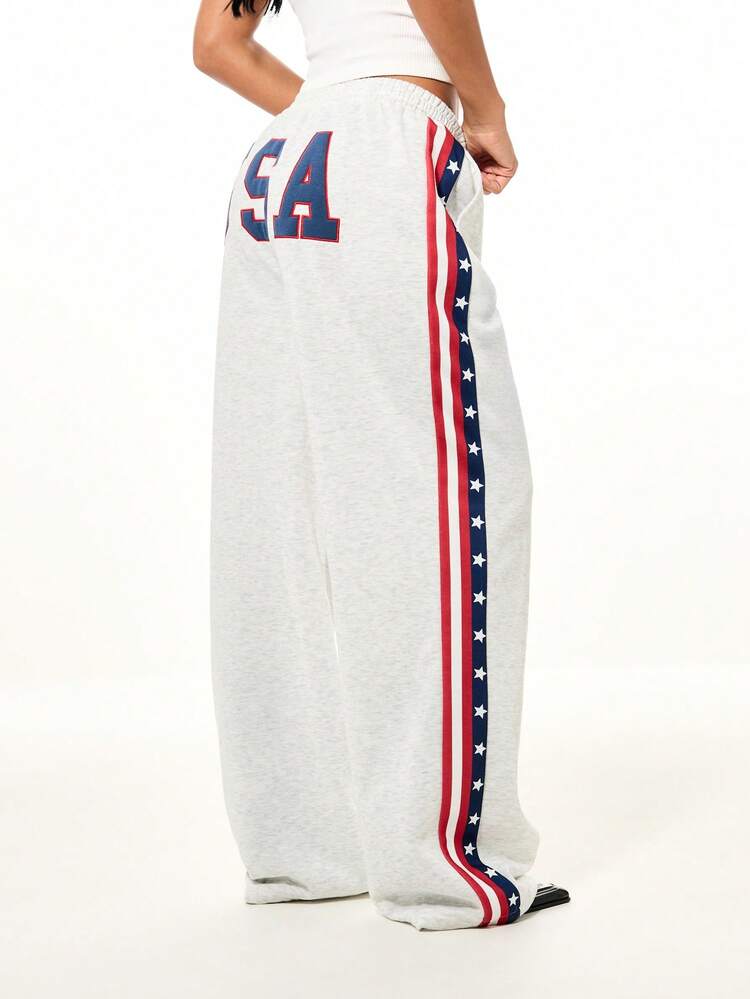 SUMWON WOMEN Patriotic Wide Leg Joggers With USA Flag Side Stripe Design And Lace Up Front Waist Tie Detail For Casual Weekend Wear